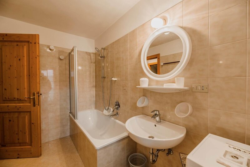 bathroom with shower, bath tub and washing machine